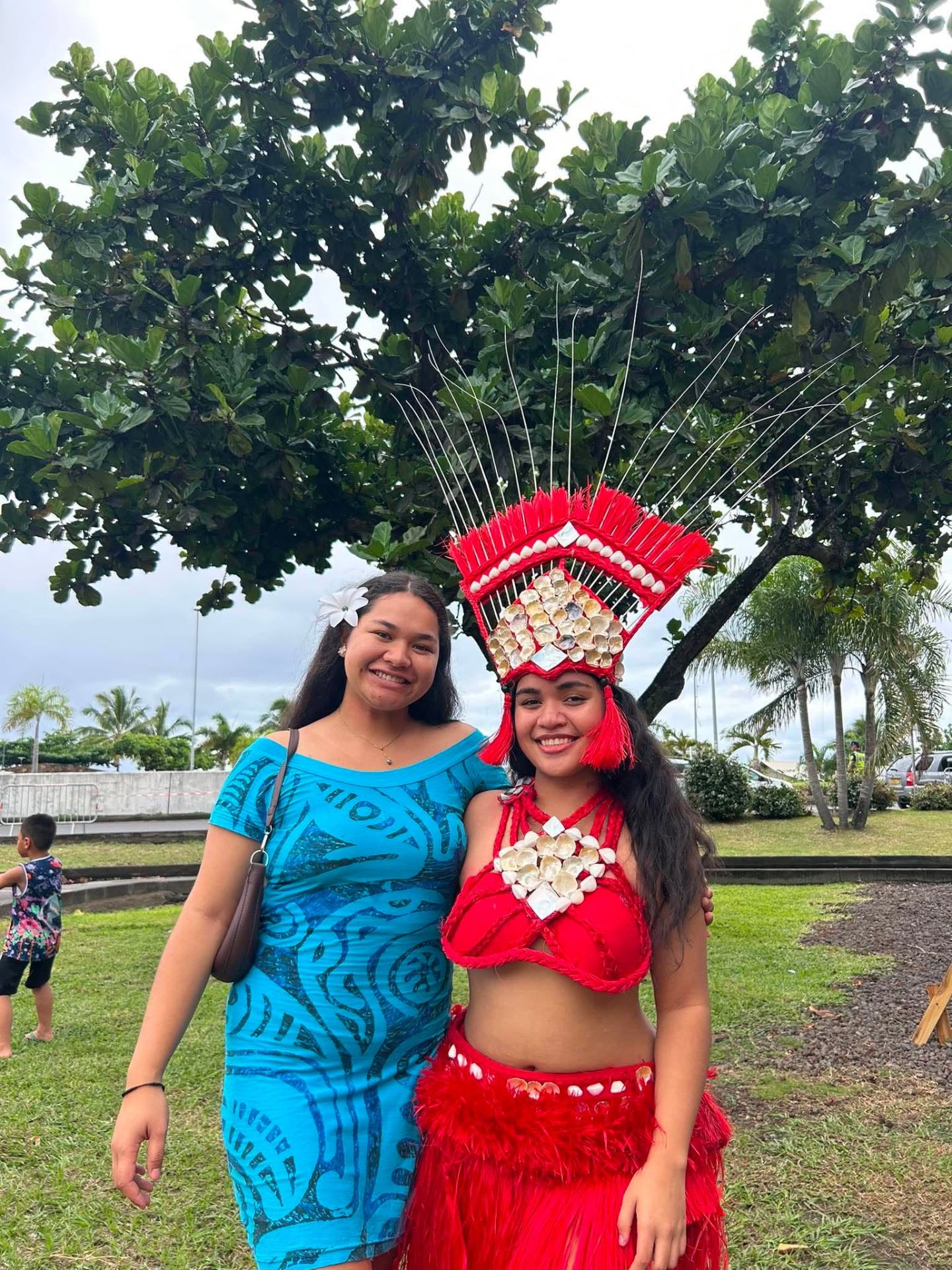 Léa en tenue traditionnelle bleue aux côtés d'une danseuse en costume rouge